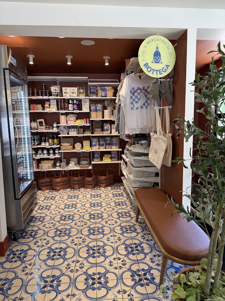 Inside Il Mercatino at Bottega: shelves of pasta, pantry goods and totes